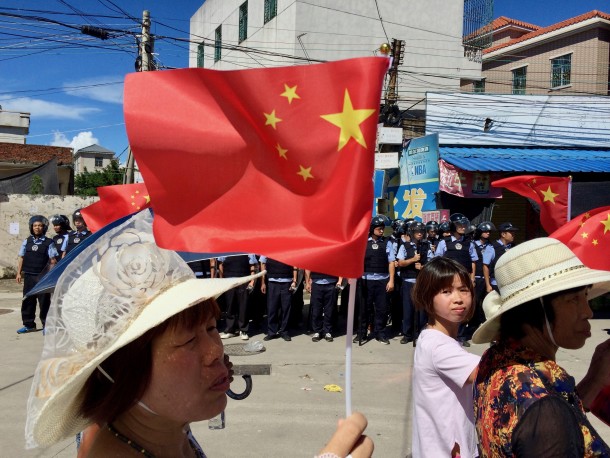Protestors in Wukan march past hundreds of armed police